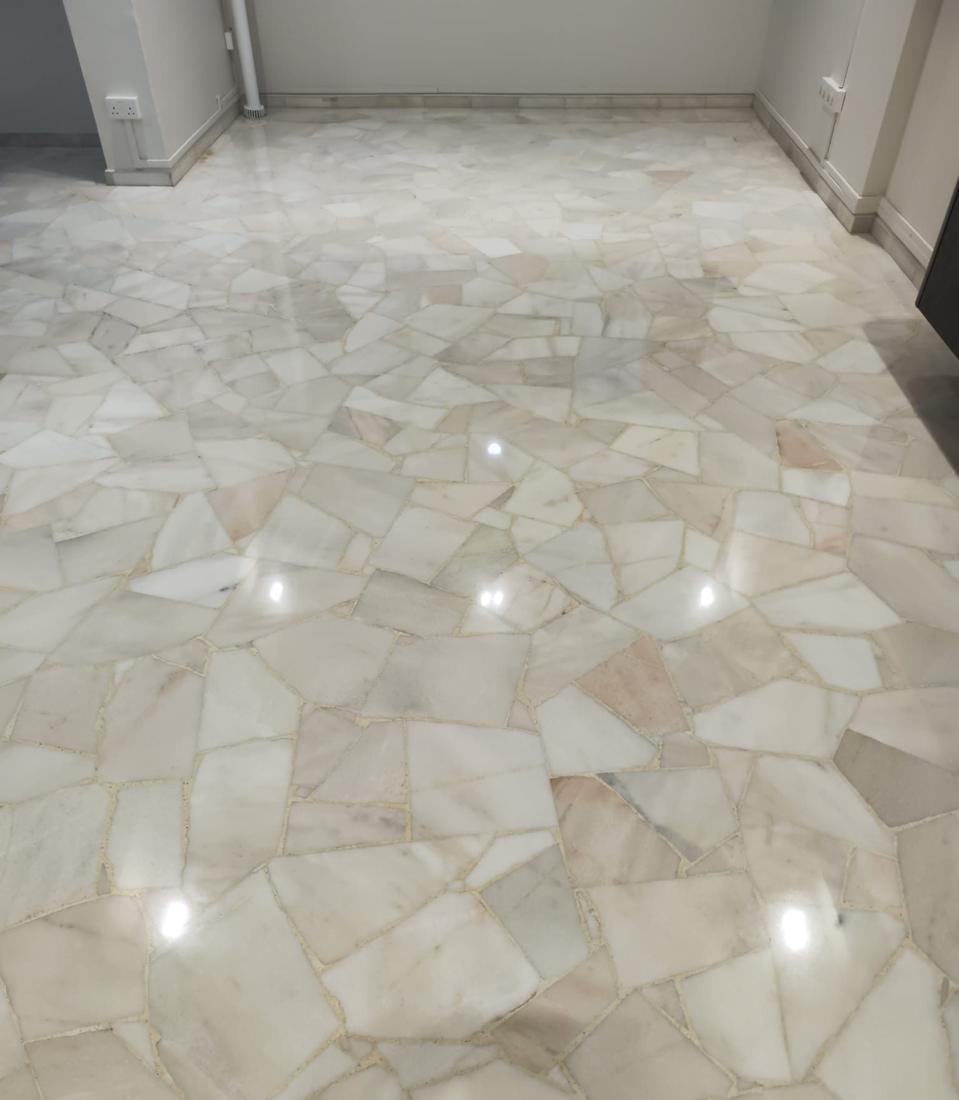 Crazy-paving marble living room floor in an HDB flat after polishing