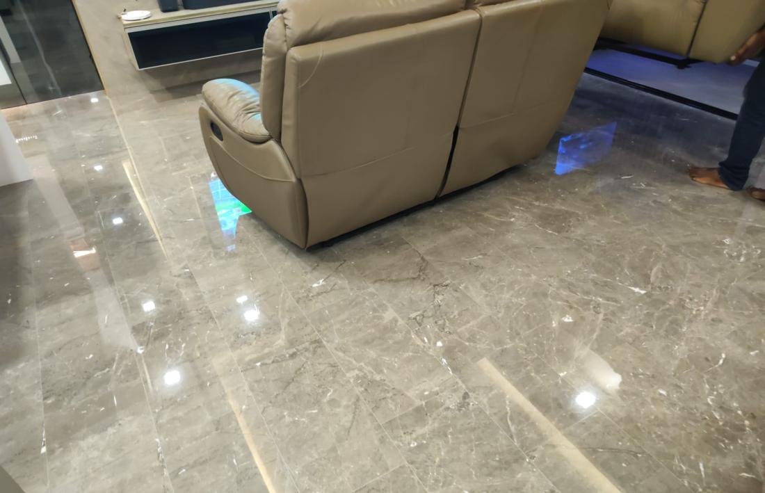 Sofa reflected in a polished grey marble floor
