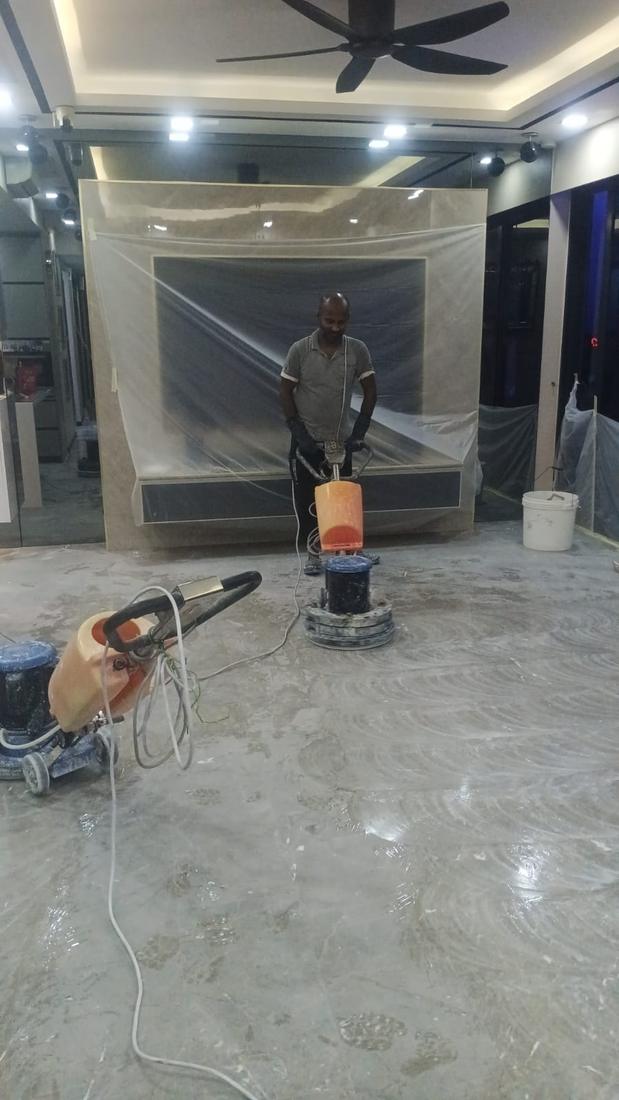 Floor machine polishing a marble living room