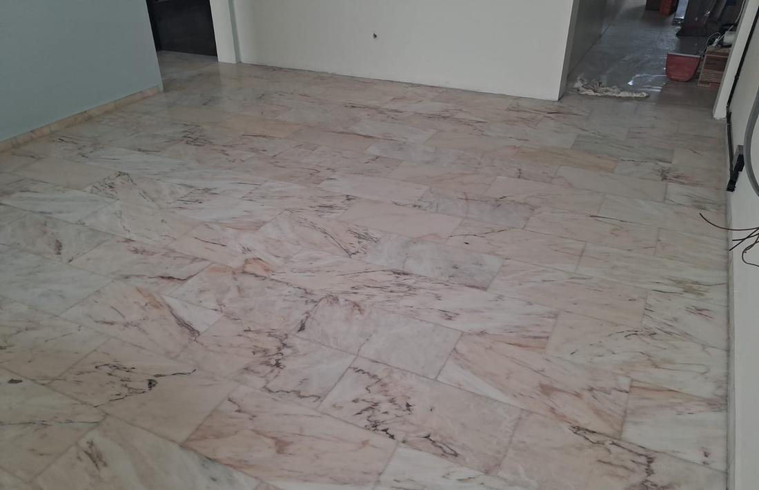 Rose marble floor with scratches and dull patches